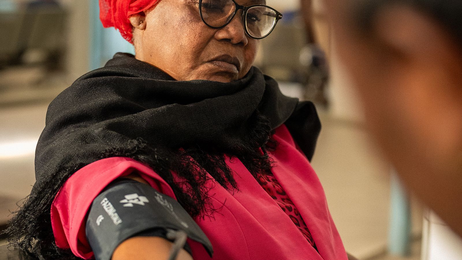 Mary Mwinqira, a patient living with diabetes, has her blood pressure taken, Dar es Salaam, Tanzania