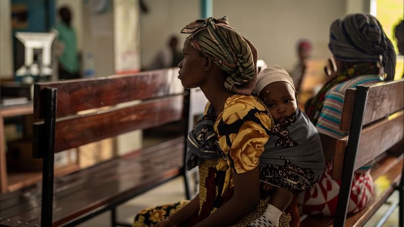 A mother and her child sitting in the waiting area of Buguruni Angelical Health Center, Dar es Salaam, Tanzania